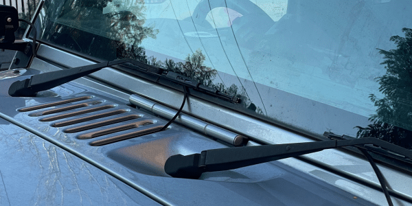 Old conventional wiper blades on a Jeep with failing rubber